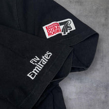 Load image into Gallery viewer, Gilbert Emirates Dubai Rugby 7’S “Lace Up” Spellout Graphic T-Shirt
